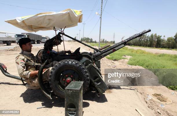 Iraqi soldiers man an anti-aircraft gun in the central city of Karbala on June 14 to prepare for any militant offensive. Shiite Iran offered to...