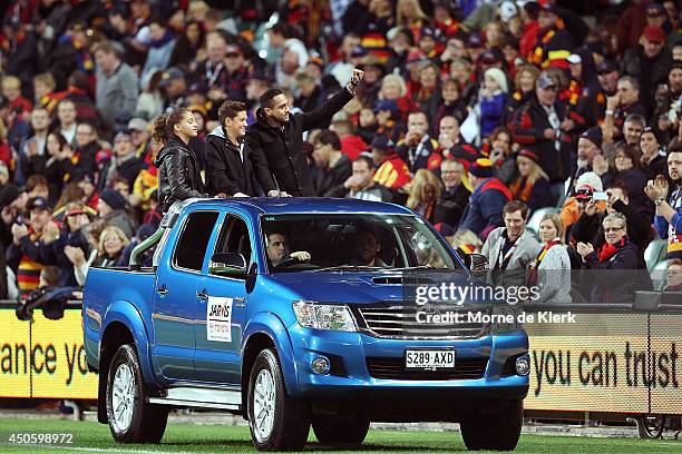Former Adelaide Crows player Andrew McLeod completes a lap of honour on the back of a ute with his family before the round 13 AFL match between the...