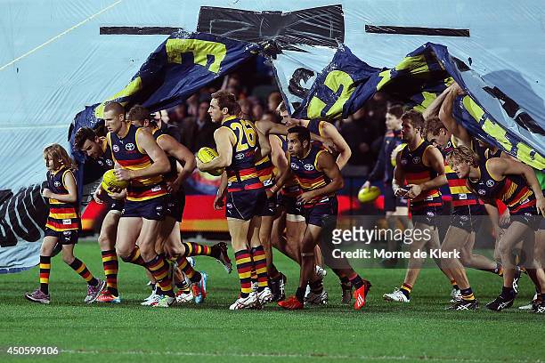 Adelaide Crows players take to the field before the round 13 AFL match between the Adelaide Crows and the North Melbourne Kangaroos at Adelaide Oval...