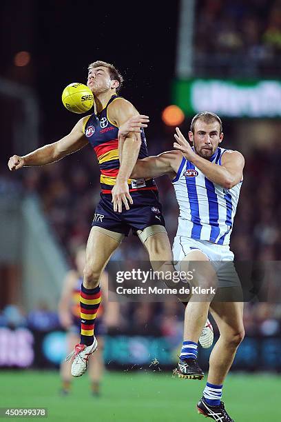 Richard Douglas of the Crows competes for the ball with Ben Cunnington of the Kangaroos during the round 13 AFL match between the Adelaide Crows and...