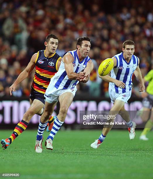 Michael Firrito of the Kangaroos passes the ball during the round 13 AFL match between the Adelaide Crows and the North Melbourne Kangaroos at...