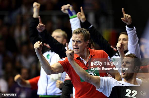 Head coach Martin Heuberger of Germany celebrates during the IHF World Championship 2015 Playoff Leg Two between Germany and Poland at Getec-Arena on...