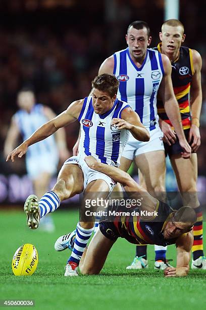 Scott Thompson of the Crows competes for the ball with Andrew Swallow of the Kangaroos during the round 13 AFL match between the Adelaide Crows and...