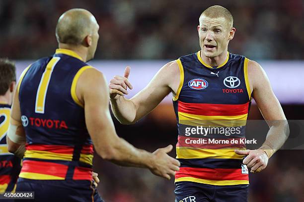 Sam Jacobs of the Crows speaks to teammate James Podsiadly during the round 13 AFL match between the Adelaide Crows and the North Melbourne Kangaroos...