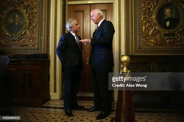 Senator Bob Corker listens to Senator Saxby Chambliss as they leave after the Senate Republican weekly policy luncheon November 19, 2013 on Capitol...