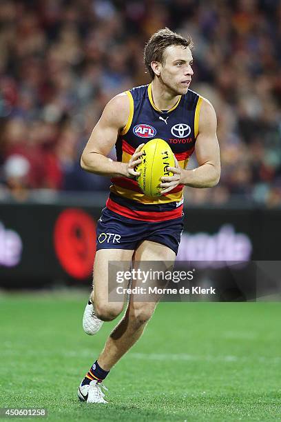 Brodie Smith of the Crows runs with the ball during the round 13 AFL match between the Adelaide Crows and the North Melbourne Kangaroos at Adelaide...