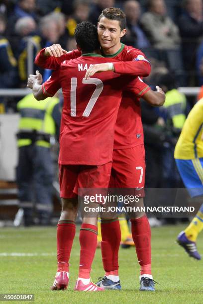 Portugal's forward Cristiano Ronaldo celebrates with Portugal's forward Nani the 2-3 win at the Friends Arena in Solna, near Stockholm on November...
