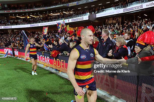 Scott Thompson of the Crows celebrates with spectators after the round 13 AFL match between the Adelaide Crows and the North Melbourne Kangaroos at...