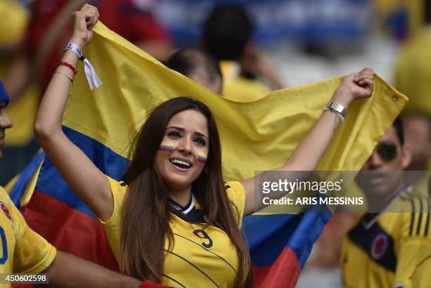 Colombia fan holds her national flag before a Group C football match between Colombia and Greece at the Mineirao Arena in Belo Horizonte during the...