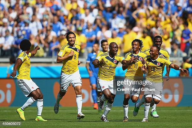 Pablo Armero of Colombia celebrates with teammates after scoring his team's first goal during the 2014 FIFA World Cup Brazil Group C match between...