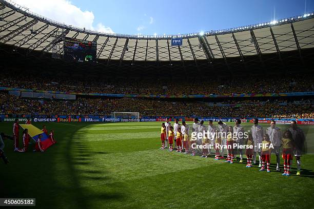 Players of Colombia line up with player escorts prior to the 2014 FIFA World Cup Brazil Group C match between Colombia and Greece at Estadio Mineirao...
