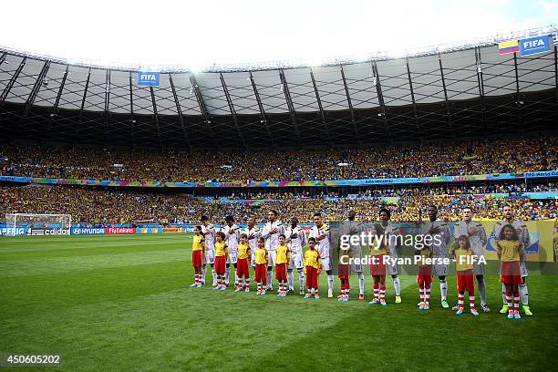 Players of Colombia line up with player escorts prior to the 2014 FIFA World Cup Brazil Group C match between Colombia and Greece at Estadio Mineirao...