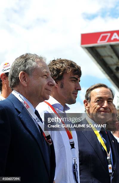 Federation Internationale de l'Automobile president Jean Todt, Italian driver Fernando Alonso and Sir Lindsay Owen Jones pose for a photograph in a...