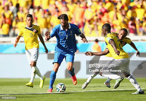 Giorgos Samaras of Greece controls the ball as Cristian Zapata of Colombia gives chase during the 2014 FIFA World Cup Brazil Group C match between...