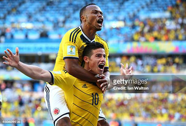 James Rodriguez of Colombia celebrates scoring his team's third goal with Juan Camilo Zuniga during the 2014 FIFA World Cup Brazil Group C match...