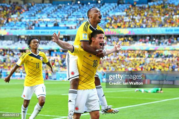 James Rodriguez of Colombia celebrates scoring his team's third goal with Juan Camilo Zuniga during the 2014 FIFA World Cup Brazil Group C match...