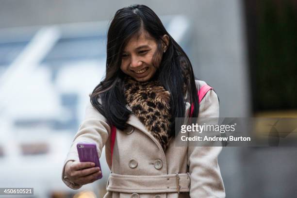 Woman takes a "selfie" outside Rockefeller Center on November 19, 2013 in New York City. Oxford Dictionary named "Selfie" the new word of the year....