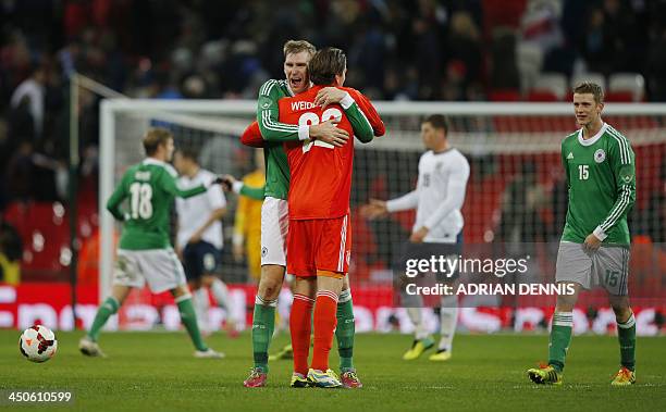 Germany's defender Per Mertesacker celebrates with goalkeeper Roman Weidenfeller after winning 1-0 during an international friendly football match...