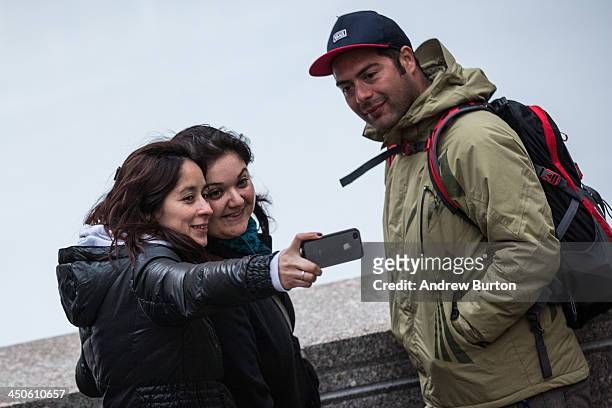 Three people take a "selfie" outside Rockefeller Center on November 19, 2013 in New York City. Oxford Dictionary named "Selfie" the new word of the...