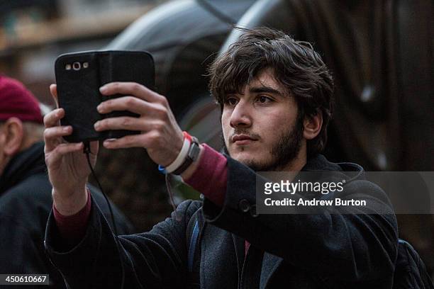 Man takes a "selfie" outside Rockefeller Center on November 19, 2013 in New York City. Oxford Dictionary named "Selfie" the new word of the year. The...