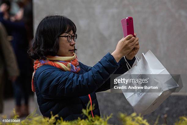 Woman takes a "selfie" outside Rockefeller Center on November 19, 2013 in New York City. Oxford Dictionary named "Selfie" the new word of the year....