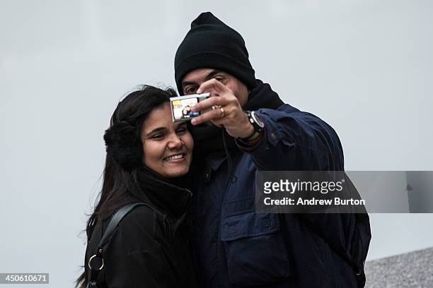 Couple takes a "selfie" outside Rockefeller Center on November 19, 2013 in New York City. Oxford Dictionary named "Selfie" the new word of the year....