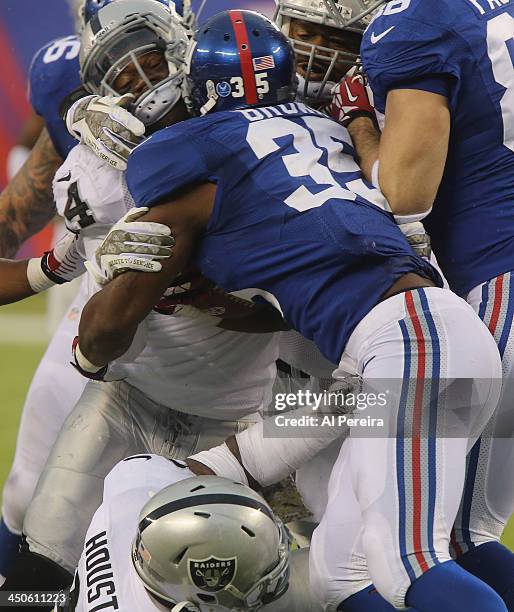 Linebacker Kevin Burnett of the Oakland Raiders makes a stop against the New York Giants at MetLife Stadium on November 10, 2013 in East Rutherford,...