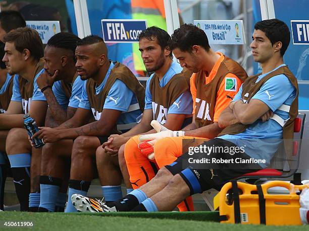 Luis Suarez of Uruguay sits on the bench at the start of the 2014 FIFA World Cup Brazil Group D match between Uruguay and Costa Rica at Castelao on...