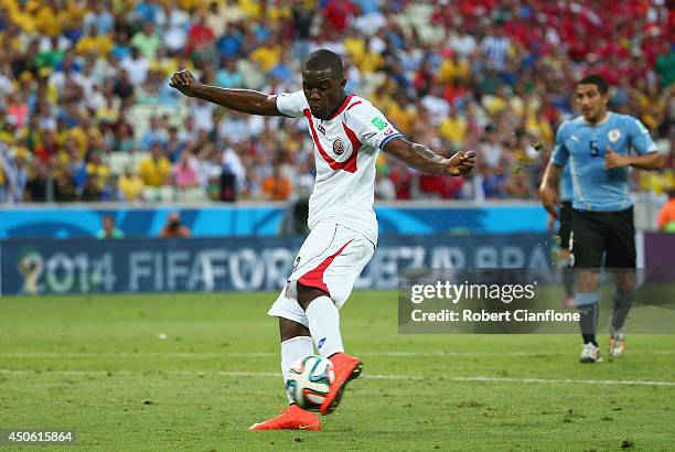 Joel Campbell of Costa Rica shoots and scores his team's first goal during the 2014 FIFA World Cup Brazil Group D match between Uruguay and Costa...