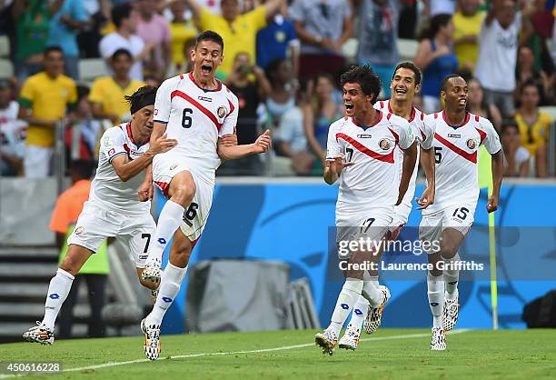 Oscar Duarte of Costa Rica celebrates scoring his team's second goal with teammates during the 2014 FIFA World Cup Brazil Group D match between...