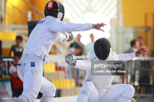 Jhon Rodriguez of Colombia competes with Francisco Limardo of Venezuela during a fencing event as part of the XVII Bolivarian Games Trujillo 2013 at...