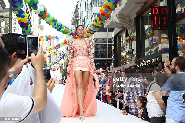 Model walks the runway during the "Osmanbey Weekend" street fashion show within the Istanbul Shopping fest held at Istanbul's residential street of...