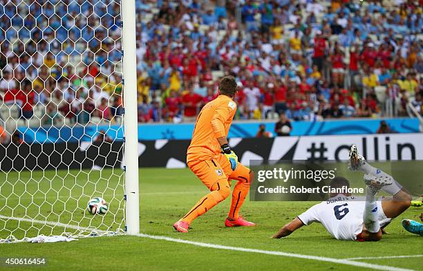 Oscar Duarte of Costa Rica puts the ball past Fernando Muslera of Uruguay on a diving header for his team's second goal during the 2014 FIFA World...