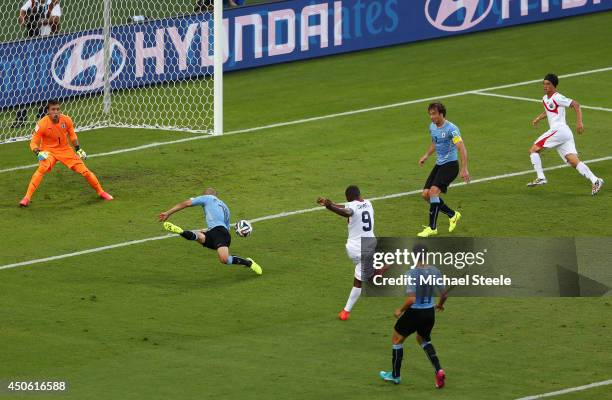 Joel Campbell of Costa Rica shoots and scores his team's first goal past Fernando Muslera of Uruguay during the 2014 FIFA World Cup Brazil Group D...