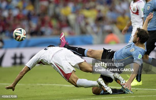 Costa Rica's defender Oscar Duarte heads the ball to score during a Group D football match between Uruguay and Costa Rica at the Castelao Stadium in...