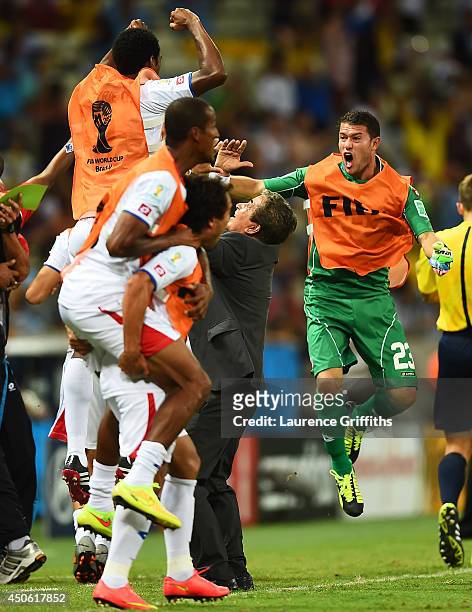 Head coach Jorge Luis Pinto of Costa Rica celebrates on the sidelines after his team's third goal during the 2014 FIFA World Cup Brazil Group D match...