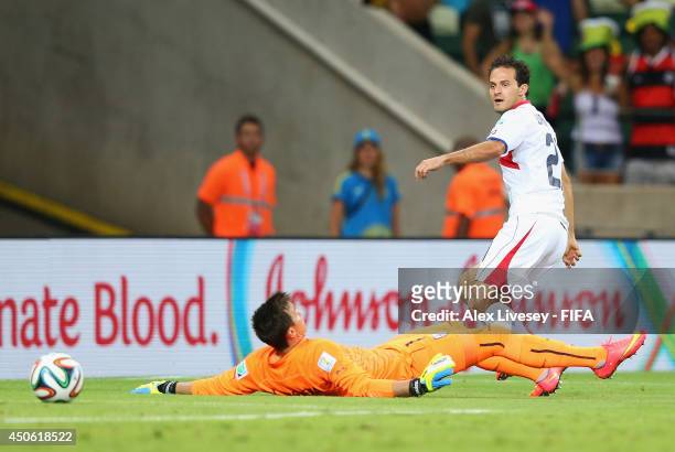 Marco Urena of Costa Rica scores the team's third goal past Fernando Muslera of Uruguay during the 2014 FIFA World Cup Brazil Group D match between...