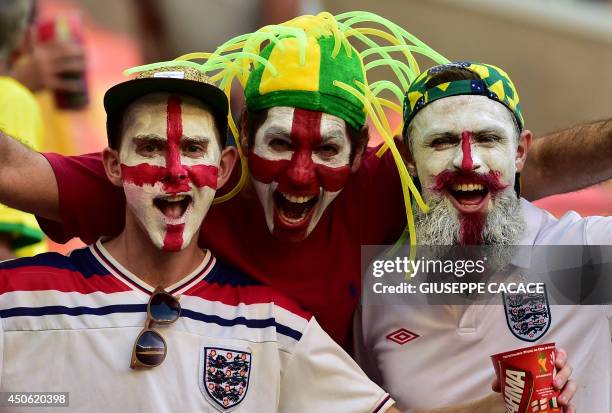 England fans with their faces painted in the colours of their national flag cheer before the kick-off of a Group D football match between England and...