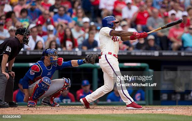 Shortstop Jimmy Rollins of the Philadelphia Phillies hits a single in the bottom of the fifth inning against the Chicago Cubs on June 14, 2014 at...