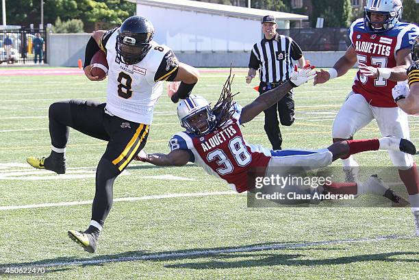Dominique Ellis of the Montreal Alouettes misses a tackle on Jeremiah Masoli of the Hamilton Tiger-Cats in a pre-season CFL football game at Ivor...