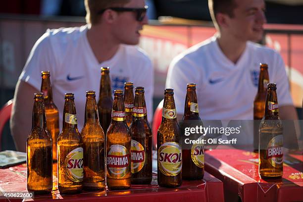 Empty beer bottles are stacked on a table of England football fans as they watch the game between Uruguay and Costa Rica in the FIFA World Cup on...