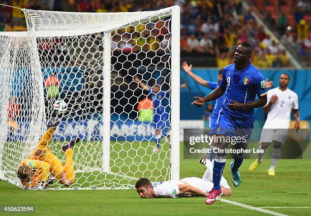 Mario Balotelli of Italy celebrates after scoring his team's second goal on a header past Gary Cahill and goalkeeper Joe Hart of England during the...