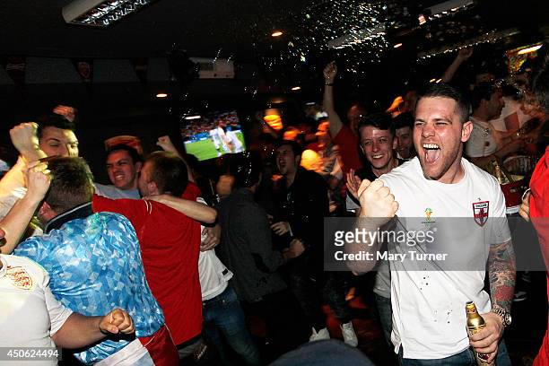 England football fans go wild in Riley's Sports Bar as their team equalise against Italy in their opening match of the 2014 FIFA World Cup on June...