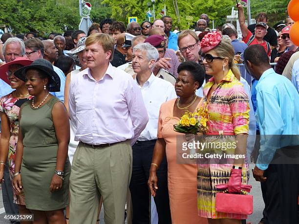 King Willem-Alexander of the Netherlands and Queen Maxima of the Netherlands are greeted by locals during a visit on November 19, 2013 in Curacao,...