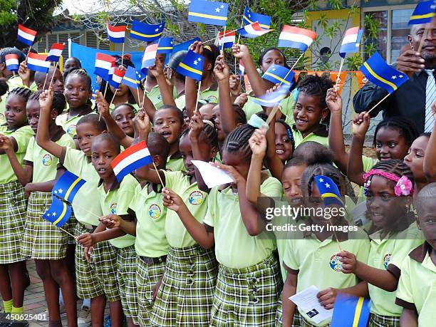 Children wait to greet King Willem-Alexander of the Netherlands and Queen Maxima of the Netherlands during their visit on November 19, 2013 in...