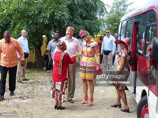 King Willem-Alexander of the Netherlands and Queen Maxima of the Netherlands are greeted by the director of the Slave Museum at Knip Plantation House...