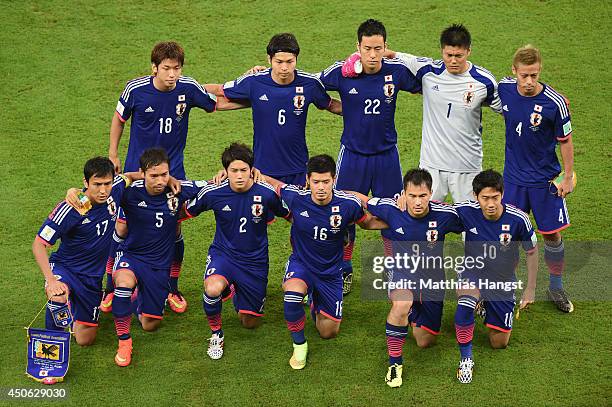 Japan pose for a team photo before the 2014 FIFA World Cup Brazil Group C match between the Ivory Coast and Japan at Arena Pernambuco on June 14,...