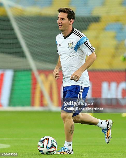 Lionel Messi of Argentina dribbles the ball during a training session at Maracana stadium on June 14, 2014 in Rio de Janeiro, Brazil.