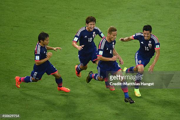 Keisuke Honda of Japan celebrates scoring his team's first goal with Yuto Nagatomo , Yuya Osako and Hotaru Yamaguchi during the 2014 FIFA World Cup...