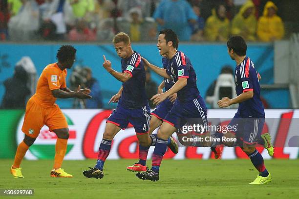 Keisuke Honda of Japan celebrates scoring the team's first goal during the 2014 FIFA World Cup Brazil Group C match between the Ivory Coast and Japan...